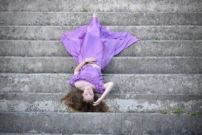 High angle view of woman lying down on steps