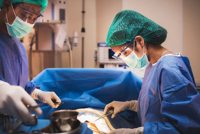 Surgeons performing surgery in operating room