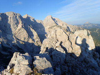 Panoramic view of rocky mountains against blue sky