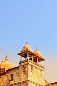 Low angle view of building against clear blue sky