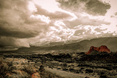 Scenic view of mountains against cloudy sky