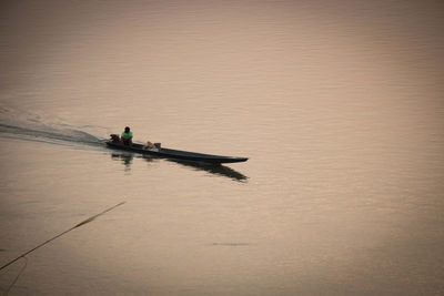 High angle view of man sitting on boat in lake