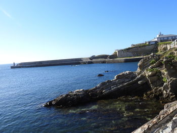 Scenic view of sea against clear blue sky