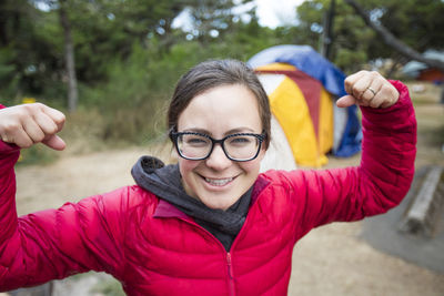Portrait of female camper showing off her muscles.