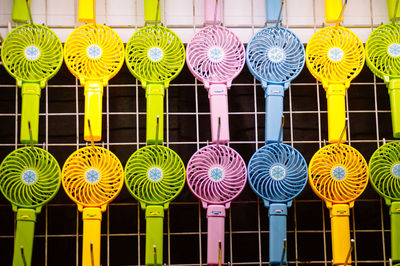 Full frame shot of colorful fans on metal grate