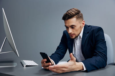 Businessman using phone at office