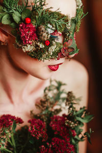 Close-up of woman with flower mask looking away