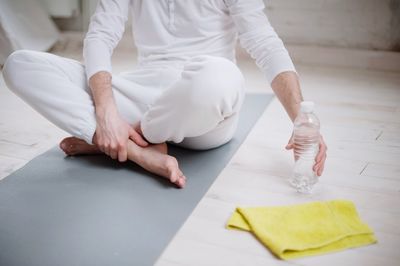 Low section of man doing yoga in studio