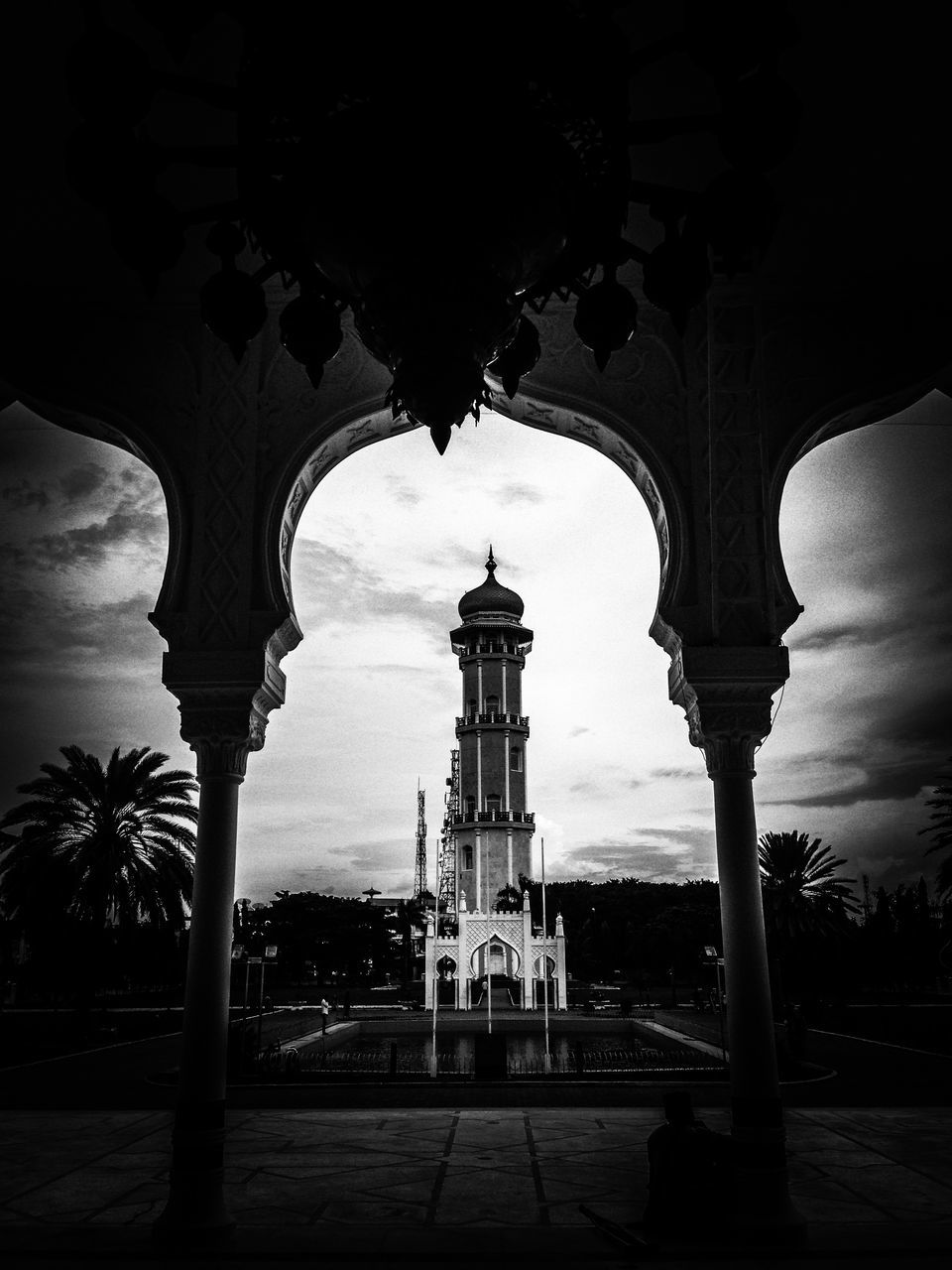 architecture, built structure, arch, building exterior, sky, architectural column, low angle view, column, silhouette, cloud - sky, incidental people, street light, travel destinations, outdoors, sunset, sunlight, history, cloud, no people, day