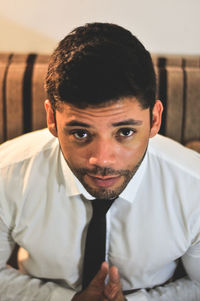 Portrait of young man sitting at home