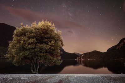 Scenic view of lake against sky at night