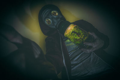 Low angle view of man wearing gas mask