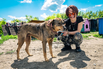 Dog at the shelter. animal shelter volunteer feeding the dogs.