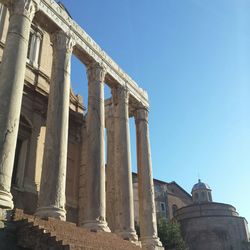 Low angle view of old ruins against blue sky