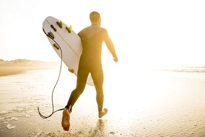 Rear view of man standing on beach