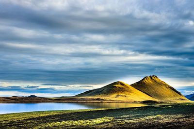 Scenic view of sea and mountains against sky