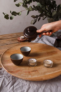 Hand holding tea cup on table