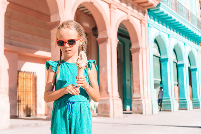 Full length of woman wearing sunglasses standing outdoors