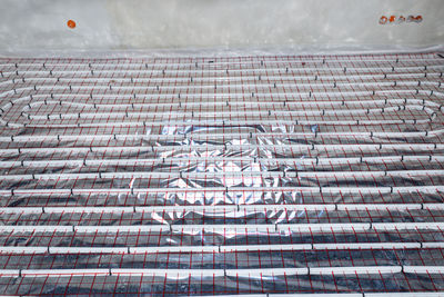 White pipes of underfloor heating systems, distributed in an individual family house on foil.