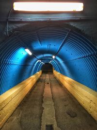 Empty illuminated subway tunnel