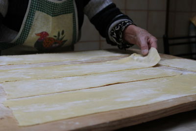 Midsection of person preparing food at table