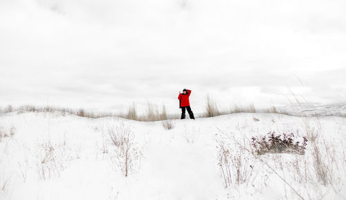 Man on snow field against sky