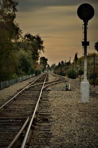 Railway tracks against sky during sunset