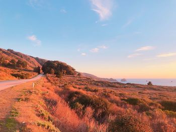 Scenic view of land against sky during sunset