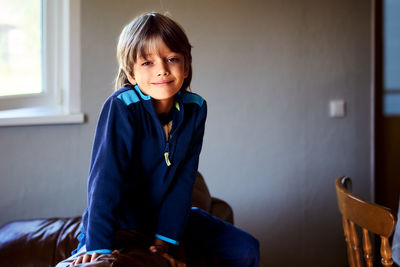 Young woman sitting on sofa at home