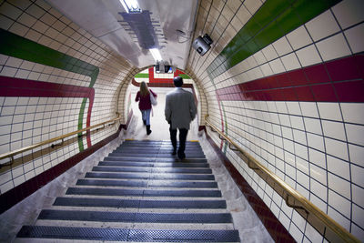 Rear view of people walking in corridor