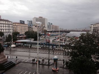 View of cityscape against cloudy sky