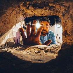 Man sitting in illuminated room