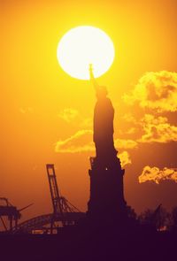 Low angle view of statue at sunset