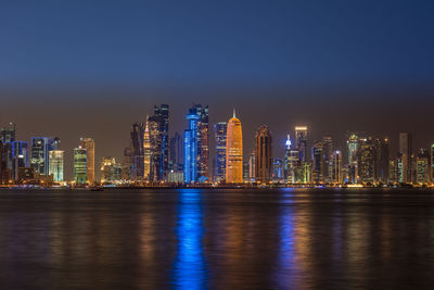 Illuminated city at waterfront