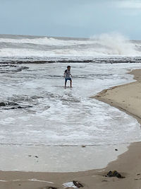 Full length of man on beach against sky