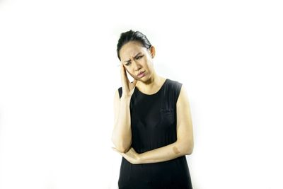 Portrait of a smiling young woman against white background