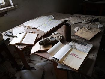 High angle view of old book on abandoned table
