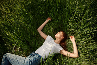 Low section of woman sitting on grass