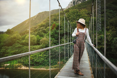 Woman standing on footbridge