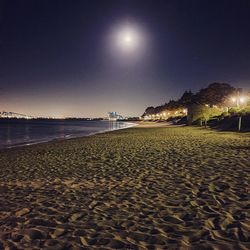 Scenic view of beach against sky at night