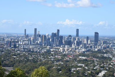 Aerial view of modern buildings in city against sky