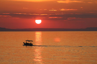 Scenic view of sea against orange sky