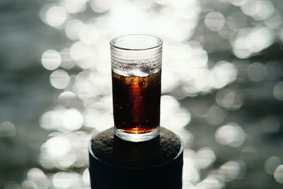 Close-up of alcohol in glass on bollard