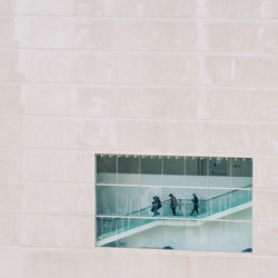 People in swimming pool against building