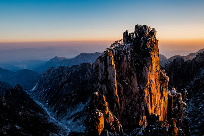 Scenic view of huangshan mountains during winter sunrise