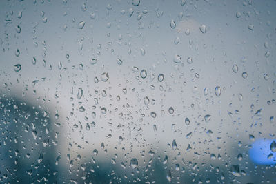 Full frame shot of raindrops on glass window