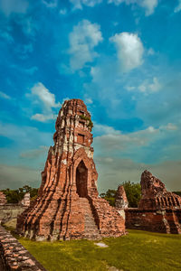 Ruins of temple against cloudy sky