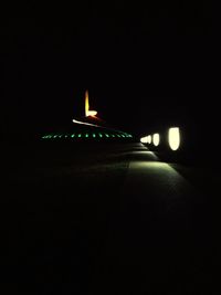 Illuminated building in darkroom