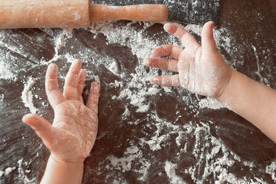 Close-up high angle view of hands on table