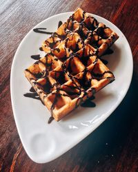 Close-up of waffle with chocolate sauce in plate
